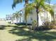 Green backyard featuring a view of waterfront and lush landscaping with palms at 4009 Triggerfish Dr, Hernando Beach, FL 34607