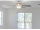 Bright bedroom with a ceiling fan and a sliding glass door leading to a balcony with railing views at 4009 Triggerfish Dr, Hernando Beach, FL 34607