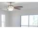 Cozy bedroom with wood floors, a ceiling fan, neutral paint, and a sliding glass door to a balcony at 4009 Triggerfish Dr, Hernando Beach, FL 34607