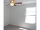 Bright bedroom features a ceiling fan and natural light from the window at 4009 Triggerfish Dr, Hernando Beach, FL 34607