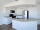 Bright kitchen featuring white cabinets, granite countertops, stainless steel appliances, and a kitchen island at 4009 Triggerfish Dr, Hernando Beach, FL 34607