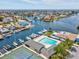 An aerial view of waterfront community with boat docks, swimming pool and tennis court at 4237 Marine Pkwy, New Port Richey, FL 34652