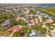 Expansive aerial view showcases the home's surroundings, including lush landscaping and nearby water access at 4237 Marine Pkwy, New Port Richey, FL 34652