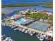 Community aerial view showcasing a pool, tennis courts, and marina along waterfront at 4237 Marine Pkwy, New Port Richey, FL 34652