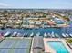 An aerial view of waterfront community with boat docks, swimming pool and tennis court at 4237 Marine Pkwy, New Port Richey, FL 34652