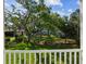 This backyard view features a well-maintained lawn with trees providing plenty of shade at 4237 Marine Pkwy, New Port Richey, FL 34652