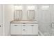 Bright bathroom featuring dual sinks, granite counters, and a glass shower at 4237 Marine Pkwy, New Port Richey, FL 34652