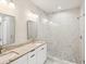 This bathroom features double sinks, granite counters, and a glass-enclosed shower at 4237 Marine Pkwy, New Port Richey, FL 34652