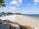 Expansive beach view with white sand, crystal blue water, and convenient picnic areas at 4237 Marine Pkwy, New Port Richey, FL 34652