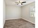 This bedroom features modern flooring, ample natural light from the window, and a ceiling fan for added comfort at 4237 Marine Pkwy, New Port Richey, FL 34652