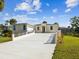 Beautiful single-story home features an expansive driveway, surrounded by vibrant greenery and a peaceful ambiance at 4237 Marine Pkwy, New Port Richey, FL 34652