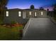 Inviting exterior of home featuring a well-manicured lawn, modern architecture, and a long driveway at 4237 Marine Pkwy, New Port Richey, FL 34652
