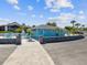Community building featuring covered patio with outdoor seating and beautiful landscaping at 4237 Marine Pkwy, New Port Richey, FL 34652