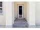 A front entryway to the home, featuring steps and a neutral color scheme at 4237 Marine Pkwy, New Port Richey, FL 34652