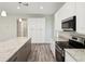 Modern kitchen island with granite countertops, wood cabinets, and stainless steel appliances at 4237 Marine Pkwy, New Port Richey, FL 34652