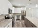 Modern kitchen with stainless steel appliances, granite countertops, and white cabinetry at 4237 Marine Pkwy, New Port Richey, FL 34652