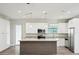 Bright kitchen featuring modern cabinets, granite countertops, and stainless steel appliances, making it a chef's dream at 4237 Marine Pkwy, New Port Richey, FL 34652