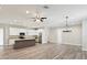 Open-concept living space with a kitchen, modern lighting, and wood-look floors at 4237 Marine Pkwy, New Port Richey, FL 34652