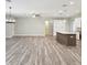 Open living space with wood-look floors and access to kitchen with an island at 4237 Marine Pkwy, New Port Richey, FL 34652