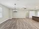 Spacious living area featuring modern lighting fixtures and wood-look flooring at 4237 Marine Pkwy, New Port Richey, FL 34652