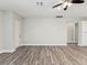 Bright, airy living room with wood-look flooring and neutral walls at 4237 Marine Pkwy, New Port Richey, FL 34652