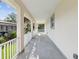 Spacious covered patio with tile flooring and white columns, offering a relaxing outdoor living space at 4237 Marine Pkwy, New Port Richey, FL 34652