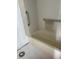 Classic bathroom with tiled walls, a standard tub, and accessible grab bars at 4557 Garnet Dr # 102, New Port Richey, FL 34652