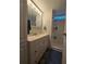 Bathroom featuring a vanity with storage and a walk-in shower at 5102 Pigeon Plum Cir, New Port Richey, FL 34653