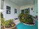 Close-up of home's entrance, showcasing the door, stairs and tropical landscaping for curb appeal at 5102 Pigeon Plum Cir, New Port Richey, FL 34653