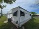 Angle shot of home's exterior showing features like awnings and well-maintained siding at 5102 Pigeon Plum Cir, New Port Richey, FL 34653