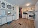 Kitchen features laminate floor, white cabinets, and essential appliances for meal preparation at 5102 Pigeon Plum Cir, New Port Richey, FL 34653