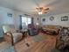 Inviting living room with comfortable seating, a ceiling fan, and wood-look floors at 5102 Pigeon Plum Cir, New Port Richey, FL 34653