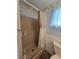 The bathroom features a stand-up shower with handrails and a white curtain at 5102 Pigeon Plum Cir, New Port Richey, FL 34653