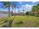 Expansive backyard with lush green lawn and mature trees, perfect for outdoor activities and relaxation at 5412 Merkin Pl, New Port Richey, FL 34655