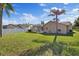 Spacious backyard with a screened in pool, beautiful landscaping, and a white fence at 5412 Merkin Pl, New Port Richey, FL 34655