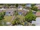 Expansive backyard featuring a screened-in pool, mature landscaping, and a secure fence, perfect for outdoor enjoyment at 5412 Merkin Pl, New Port Richey, FL 34655