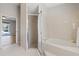 Bathroom featuring a soaking tub and glass enclosed shower at 5412 Merkin Pl, New Port Richey, FL 34655
