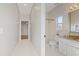 Hall bathroom featuring a shower, granite vanity, tile floors and a clear view into the bedroom at 5412 Merkin Pl, New Port Richey, FL 34655