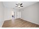 The bedroom features wood floors, neutral paint and a ceiling fan at 5412 Merkin Pl, New Port Richey, FL 34655