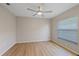 Bedroom with hardwood floors, fan and a window at 5412 Merkin Pl, New Port Richey, FL 34655