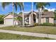 This single-Gathering home showcases an attached garage, landscaped yard, and healthy green lawn at 5412 Merkin Pl, New Port Richey, FL 34655