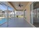 Covered lanai with ceiling fan providing serene view of the pool and back yard at 5412 Merkin Pl, New Port Richey, FL 34655