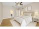 Bright main bedroom featuring a ceiling fan, and ensuite bathroom, with an open doorway at 5412 Merkin Pl, New Port Richey, FL 34655