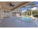 A serene pool with a unique rock water feature set against a backdrop of lush landscaping at 5412 Merkin Pl, New Port Richey, FL 34655