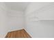 Walk-in closet with wooden floors and white wire shelving at 5412 Merkin Pl, New Port Richey, FL 34655