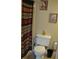 A bathroom featuring a toilet, shower with shower curtain, and framed art on the wall at 6037 Chesham Dr # 3, New Port Richey, FL 34653