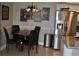 A cozy dining area features a dark wood table, four chairs, and a stainless steel refrigerator at 6037 Chesham Dr # 3, New Port Richey, FL 34653