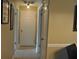 View of a neutral-colored hallway with two doorways, a wall hanging and ceramic tile flooring at 6037 Chesham Dr # 3, New Port Richey, FL 34653