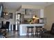 Open kitchen and dining area with breakfast bar and stainless steel appliances at 6037 Chesham Dr # 3, New Port Richey, FL 34653