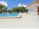 Outdoor community pool with lounge chairs and shaded areas for relaxation at 6037 Chesham Dr # 3, New Port Richey, FL 34653
